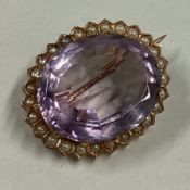 An attractive Victorian amethyst and pearl brooch in 15 carat gold claw mount.