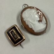 A small gold mourning brooch together with an oval cameo.