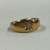 A small diamond single stone gypsy set ring in 18 carat gold setting.