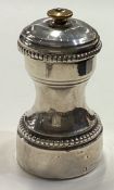 A French silver pepper grinder with beaded decoration.
