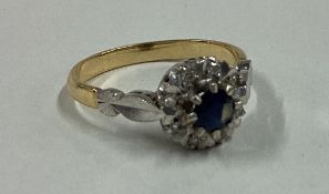 A sapphire and diamond circular cluster ring in 18 carat gold claw mount.