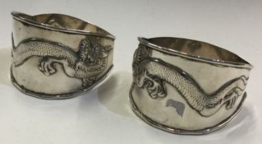 A large pair of Chinese silver napkin rings chased with dragons. Circa 1880.