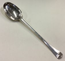 An oversized early George I silver basting spoon with central armorial to handle.