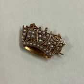 A small 9 carat brooch with pearl decoration.