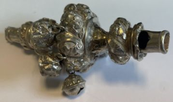 A chased Georgian silver rattle with bells.