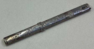 A novelty silver pencil holder.