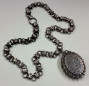 A silver locket and collar with ring clasp.