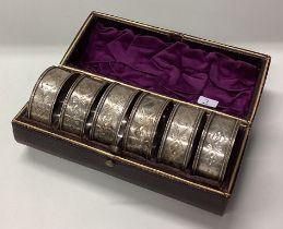 A boxed set of six silver napkin rings. Birmingham.