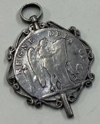 An Antique silver medallion with early coin to centre.