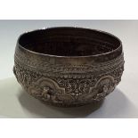 A Burmese silver panelled bowl chased with figures.