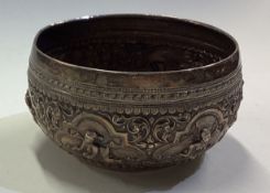 A Burmese silver panelled bowl chased with figures.