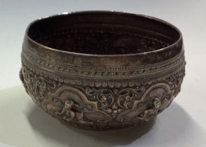 A Burmese silver panelled bowl chased with figures.