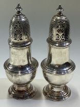 A pair of heavy 18th Century George III silver casters. By Samuel Wood.