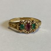 A good Victorian emerald mounted ring in 18 carat engraved gold setting.