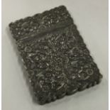 A 19th Century Indian Kutch silver card case with chased decoration.