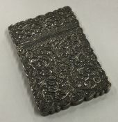 A 19th Century Indian Kutch silver card case with chased decoration.