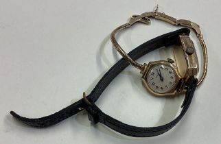 A small 9 carat wrist watch together with one other.