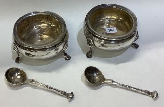 A pair of plain Georgian silver salts with glass liners.