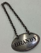 A Victorian silver wine label for 'Brandy'. By HH.
