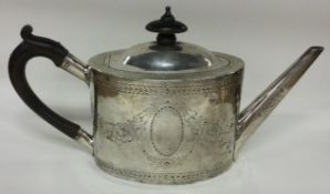 An 18th Century George III silver teapot engraved with flowers. London 1782.
