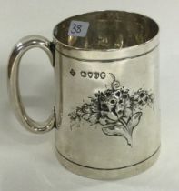 A novelty Victorian silver christening mug chased with flowers. London 1882. By Martin Hall & Co.