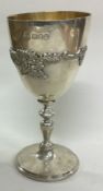 A silver goblet embossed with grape vines. London. 1976.