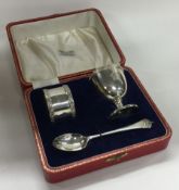 OF ROYAL INTEREST: A chased silver egg cup, napkin ring and spoon. Birmingham. By Adie Brothers Ltd.