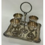 A silver four piece cruet on stand with shell border. Sheffield 1904. By Henry Aitken.