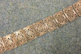 A large pierced silver plated belt.