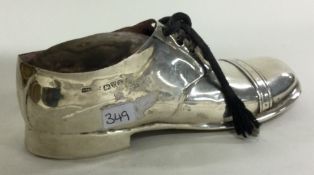CHESTER: A silver pin cushion in the form of a shoe.
