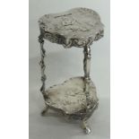 A 19th Century miniature silver table with embossed decoration, bearing import marks.