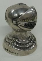 A large Victorian silver pepper with slidable cover in the form of a Knight's helmet.