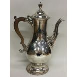 A large Georgian silver coffee pot with central armorial. London 1780. By Charles Wright.