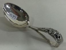 A Chinese silver feeding spoon embossed with dragons.