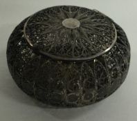 A silver filigree box with hinged lid.