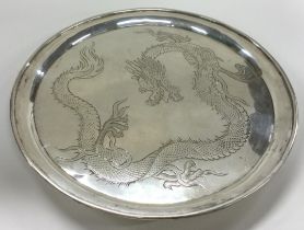 WANG HING: A Chinese export silver salver engraved with dragons.