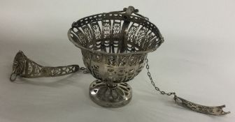 A Continental silver basket with suspension chains.