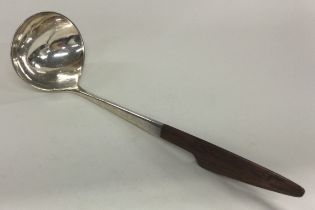 A fine Danish silver ladle with wooden handle. Marked to base.