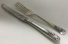 A silver christening knife and fork embossed with bears. Sheffield 1967. By Elkington & Co.