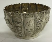 A silver paneled bowl embossed with figures and chinoiserie scenes.