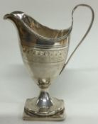 An 18th Century Georgian silver jug with bright-cut decoration.