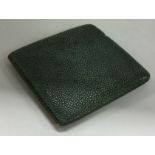 A nickel and shagreen cigarette case.