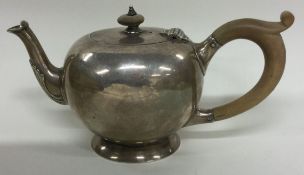 A silver bullet shaped teapot.