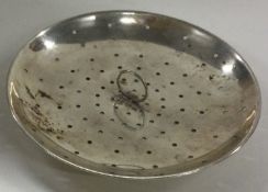 An early 20th Century silver strainer.