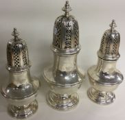 An early 18th Century suite of three silver sugar casters.