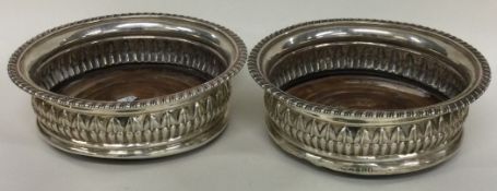 A pair of George III silver wine coasters. London 1814. By Solomon Houghman.