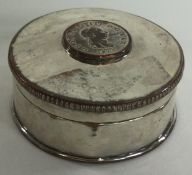 An Old Sheffield Plated snuff box with pull-off lid and coin to centre.