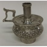 A heavy chased George III silver candle snuffer. London 1817.