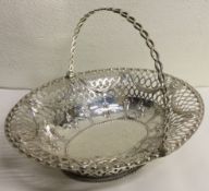 A large 18th Century Georgian silver swing handled basket. London 1772.
