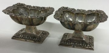 A pair of early 19th Century silver salt cellars bearing control marks to rims.